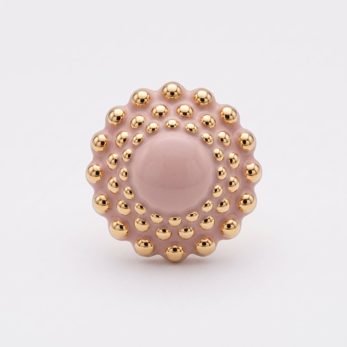 Girándola Rosa Palo — vista frontal del anillo de porcelana rosa con bultos dorados brillantes y centro liso, sobre fondo blanco