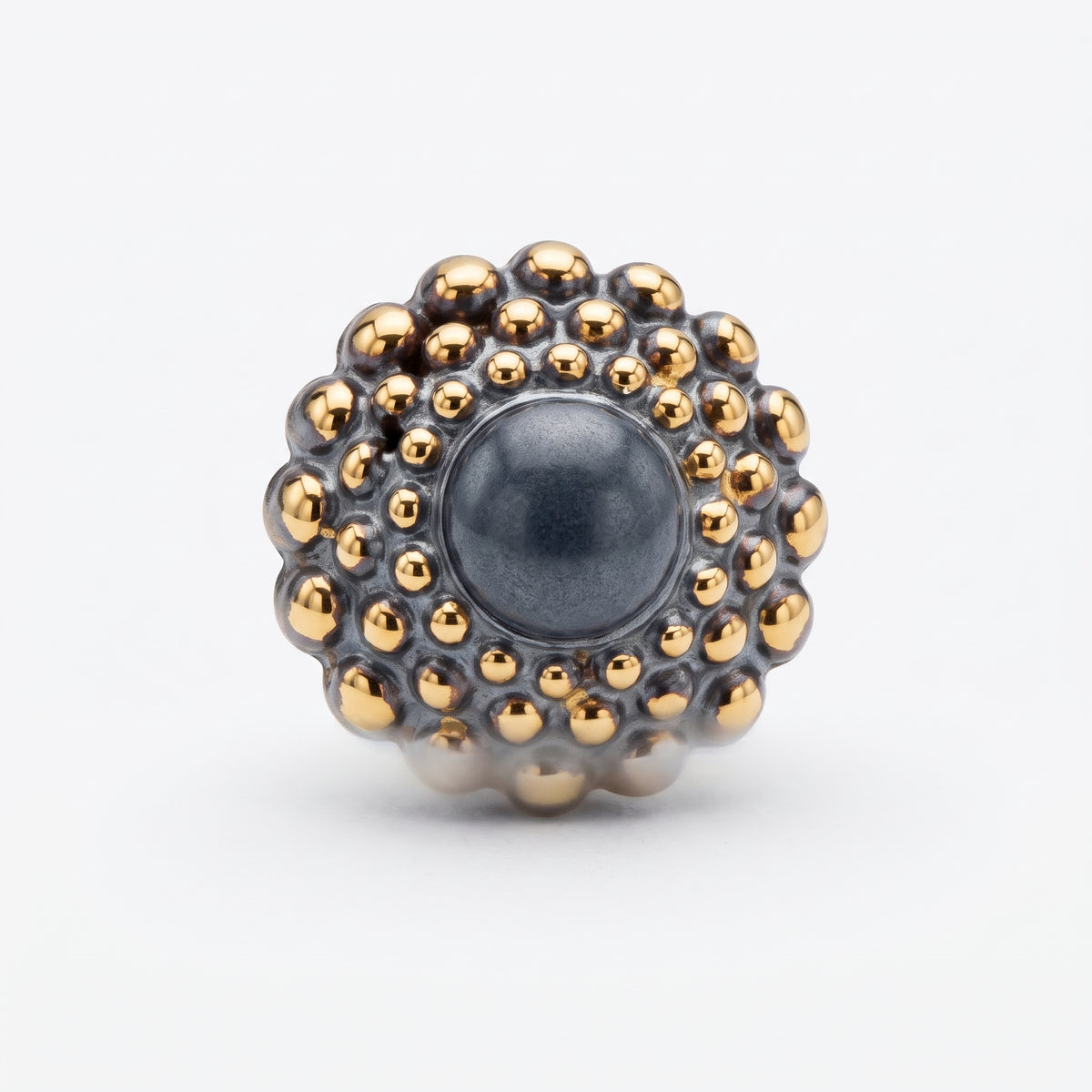 Girándola Pizarra Oro — vista frontal del anillo de porcelana gris pizarra con bultos dorados y centro gris mate, fondo blanco