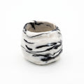 Petra Black — anillo de porcelana blanca con vetas negro intenso marmoladas, forma volumétrica orgánica, vista frontal sobre fondo blanco